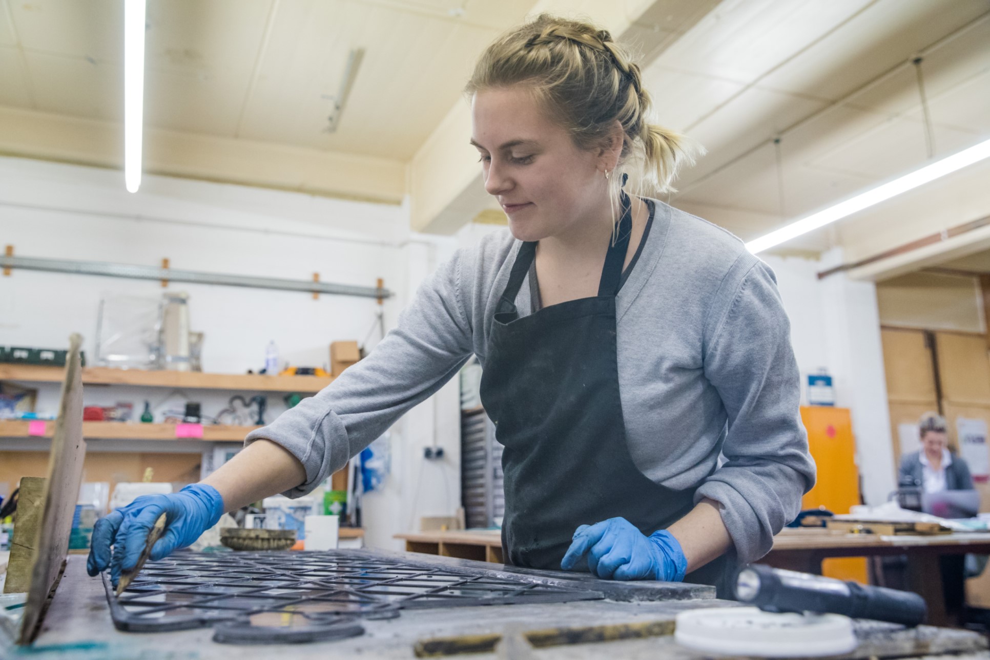 An art student creating a stained glass window in her placement year role