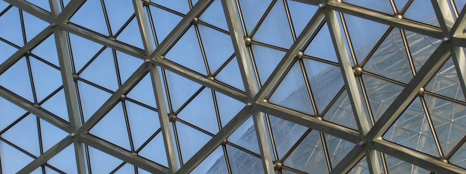 Looking out through glass domes from an indoor botanical garden.