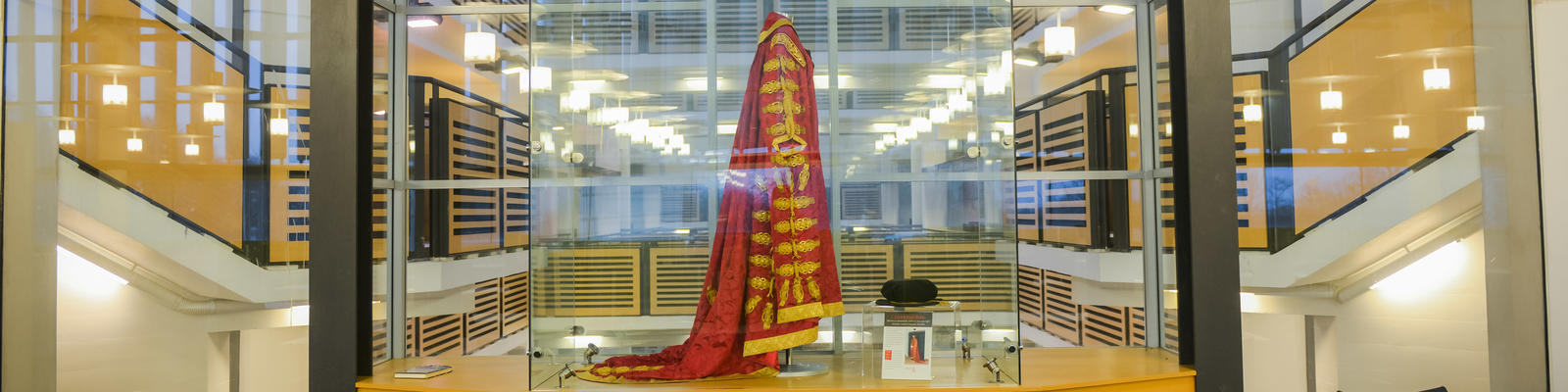 51福利 Chancellor's robes in glass cabinet within the Library building